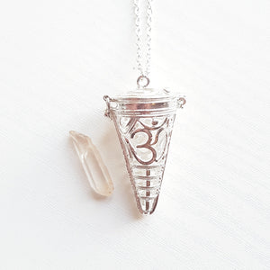 OM CAGE PENDANT WITH RAW CLEAR QUARTZ